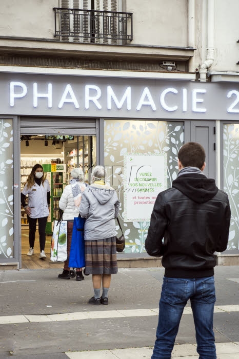 File d'attente devant une pharmacie avant instauration du confinement obligatoire